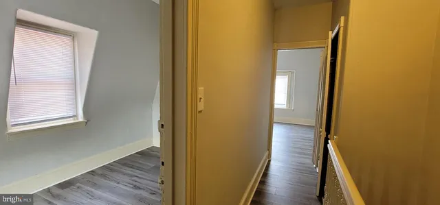a view of a hallway with wooden floor