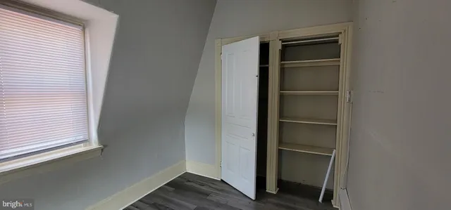 a view of walk in closet with empty racks
