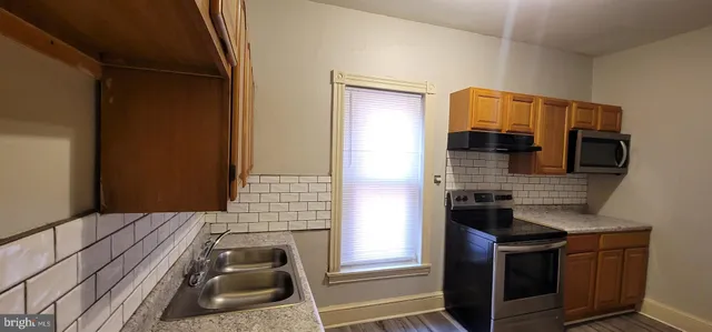 a kitchen with a refrigerator stove and a sink