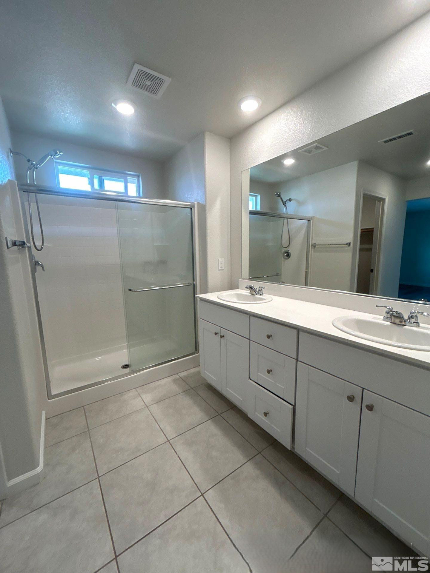 8908 Quail Falls Drive Reno, NV 89506 - Photo 13 of 20 a spacious bathroom with a shower a sink and a mirror