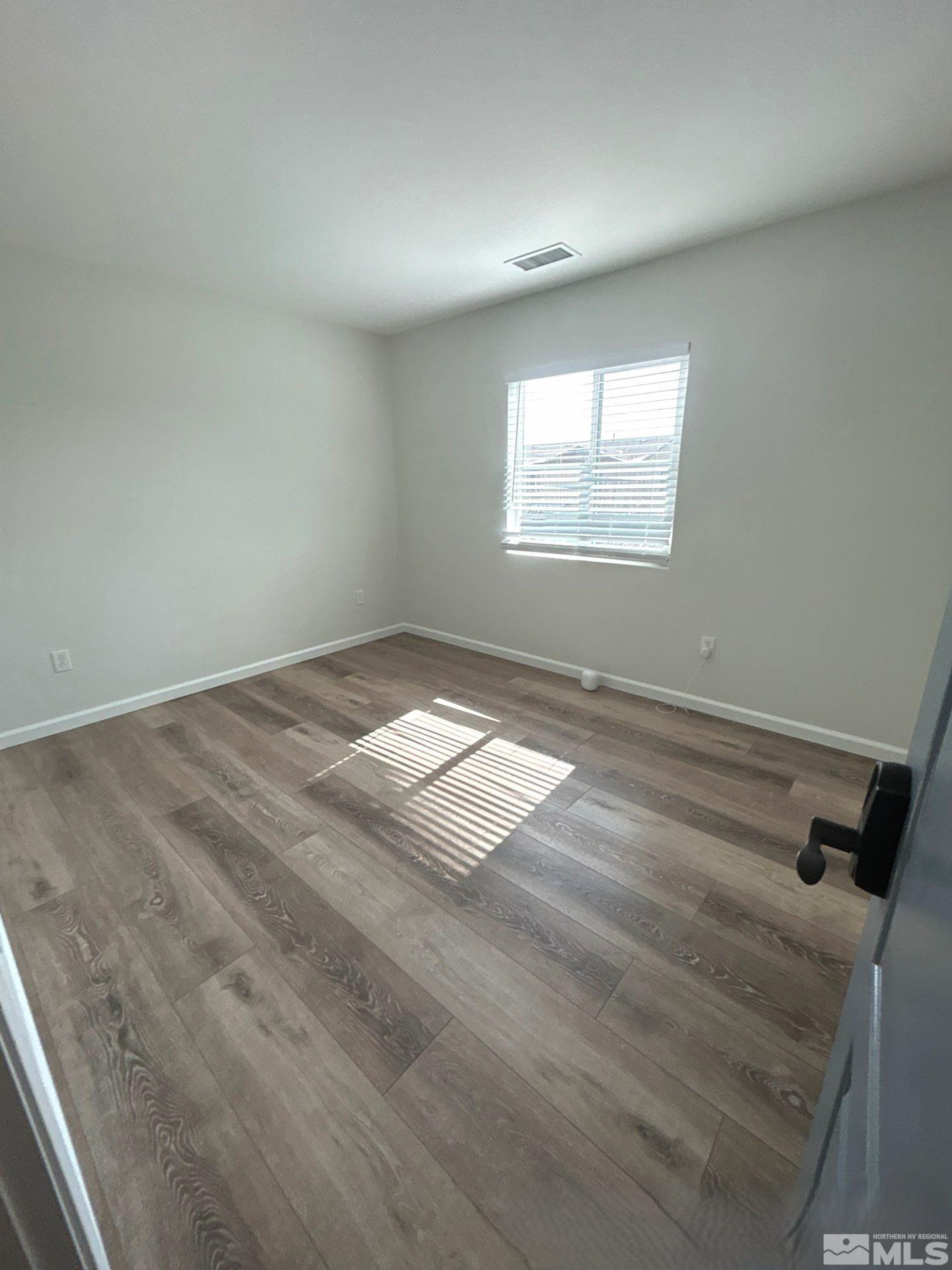 8908 Quail Falls Drive Reno, NV 89506 - Photo 5 of 20 a view of empty room with wooden floor and fan