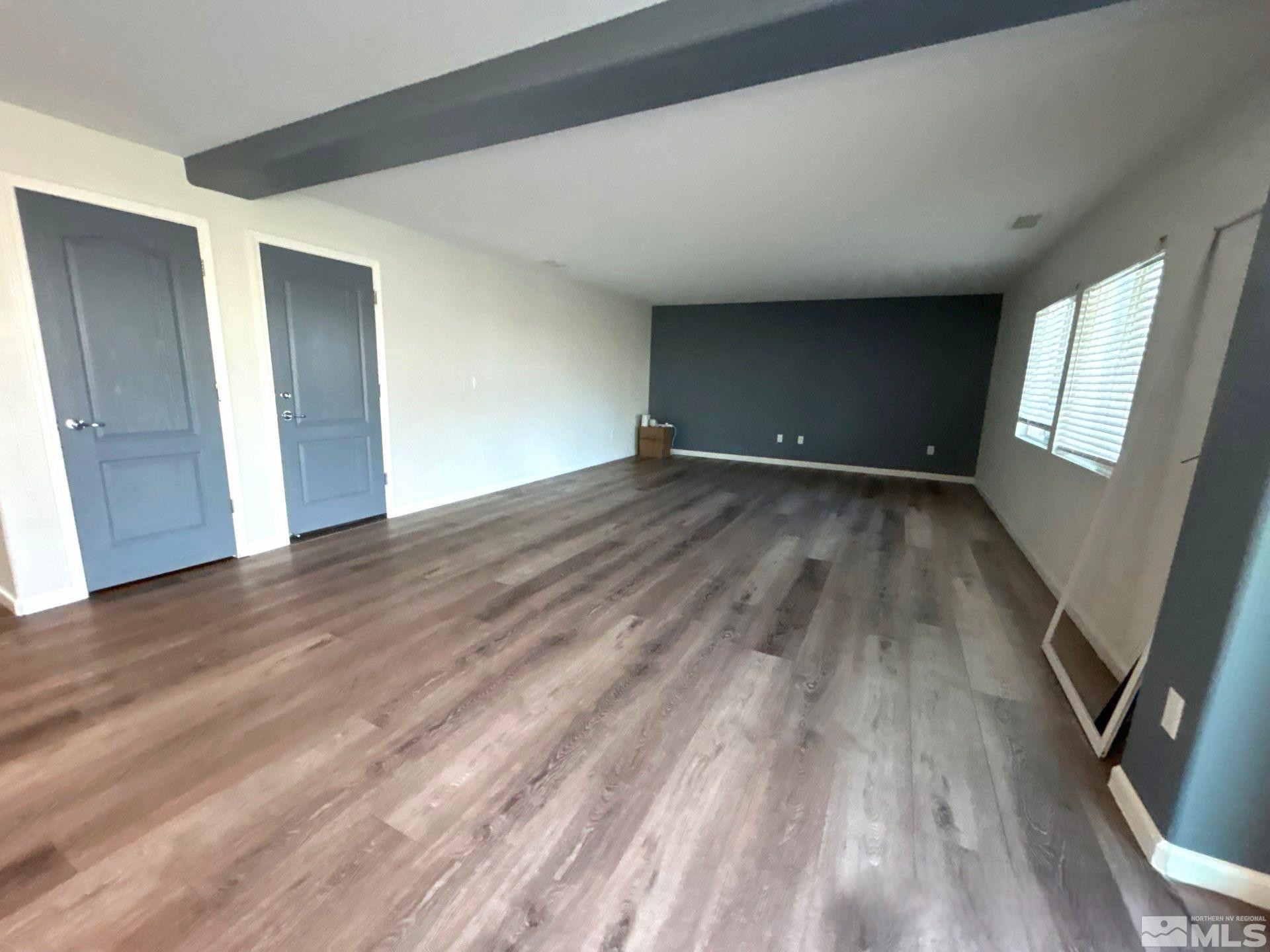 8908 Quail Falls Drive Reno, NV 89506 - Photo 9 of 20 an empty room with wooden floor and windows