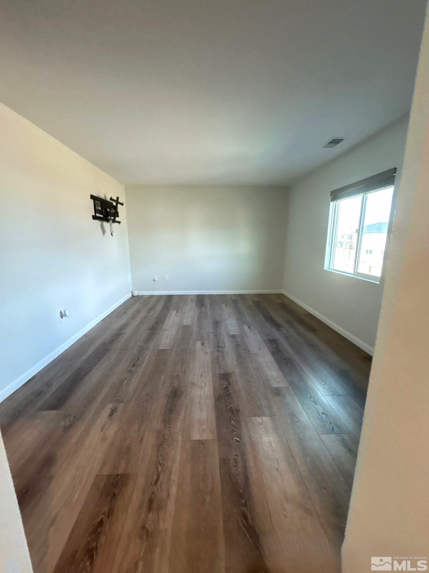 8908 Quail Falls Drive Reno, NV 89506 - Photo 10 of 20 an empty room with wooden floor and windows