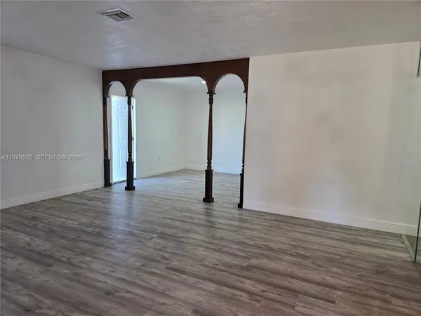 a large kitchen with a refrigerator a sink and a stove top oven