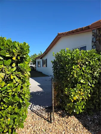 a view of a house with a flower garden