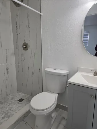 a bathroom with a sink toilet and mirror