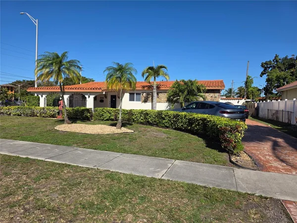 a view of a yard with cars park