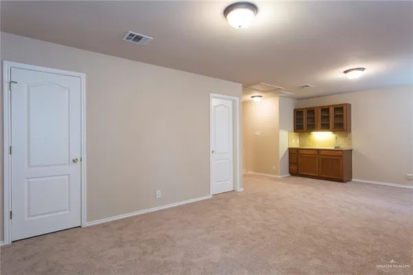 a view of an empty room with a kitchen