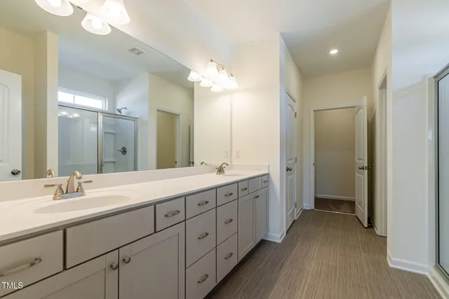 a spacious bathroom with a double vanity sink mirror and double
