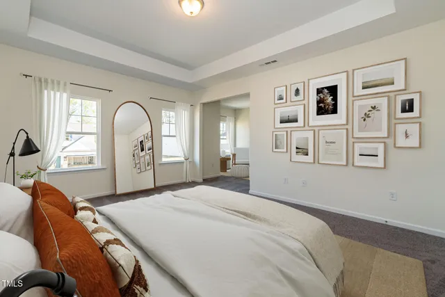 a bed room with a bed and mirror