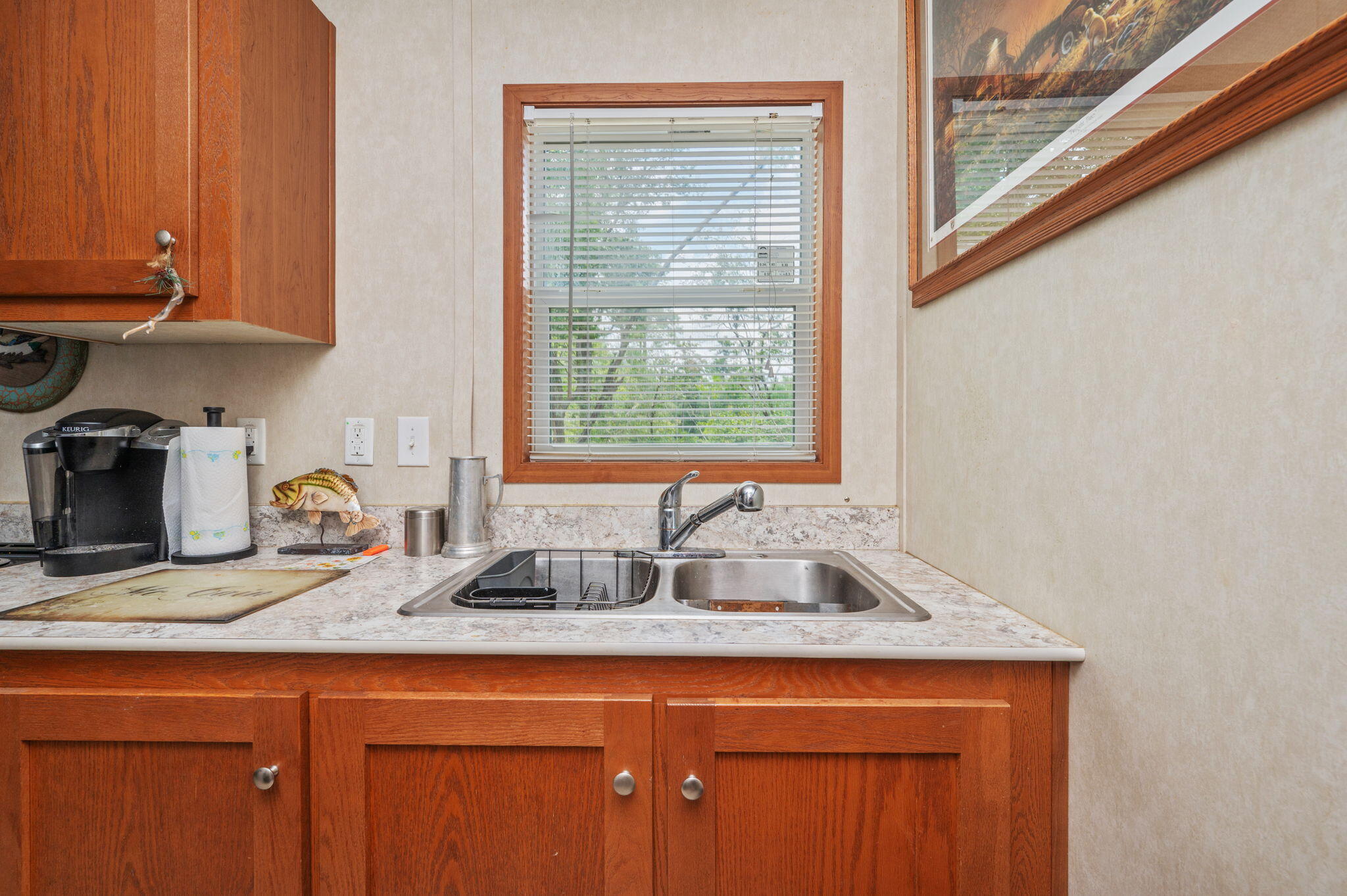 330 Dove Run Road Holt, FL 32564 - Photo 13 of 25 a kitchen with granite countertop a sink a window and cabinets