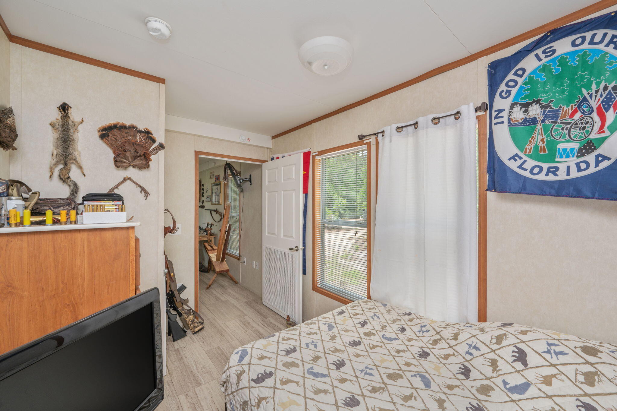 330 Dove Run Road Holt, FL 32564 - Photo 16 of 25 a bedroom with a bed and a window