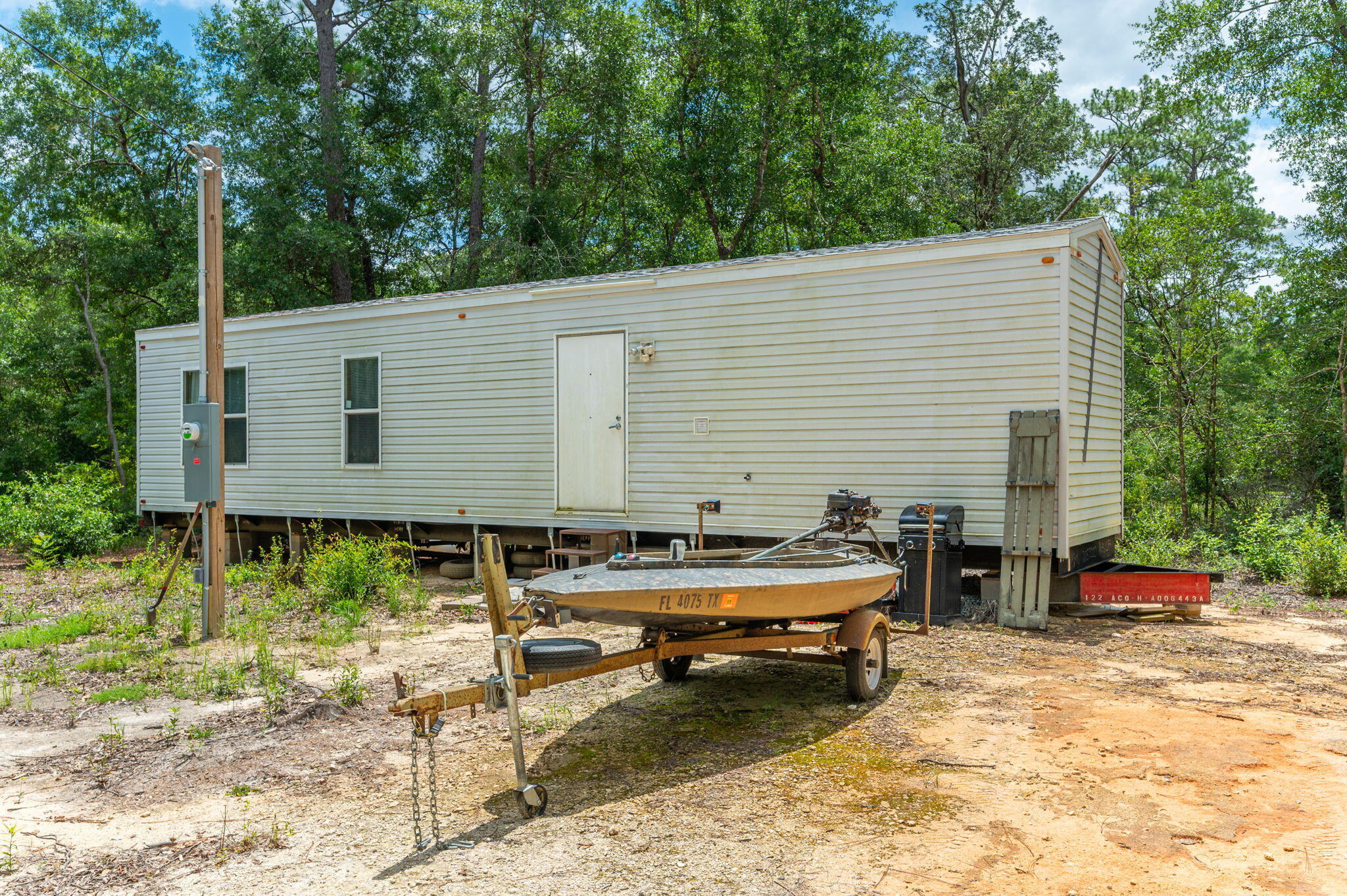 330 Dove Run Road Holt, FL 32564 - Photo 3 of 25 a backyard of a house with barbeque oven table and chairs