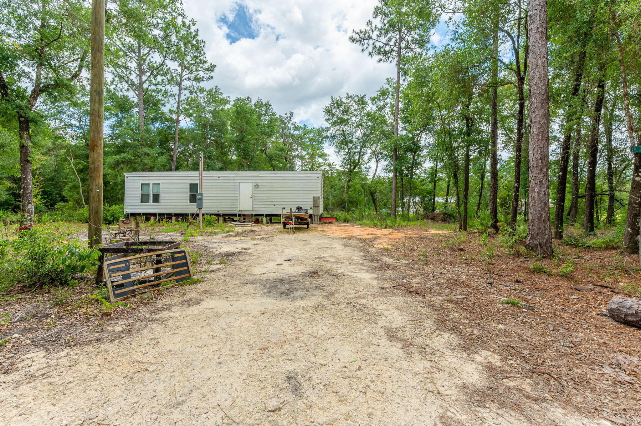 330 Dove Run Road Holt, FL 32564 - Photo 6 of 25 a view of a bench in a backyard