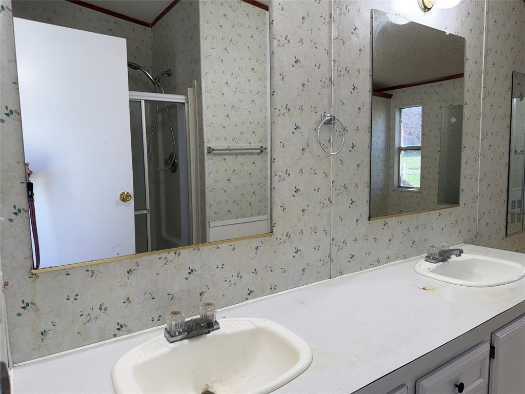 167 Blue Sky Lane Springtown, TX 76082 - Photo 11 of 34 a bathroom with a sink and a mirror