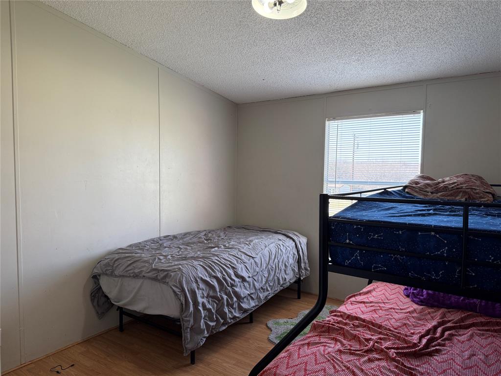 167 Blue Sky Lane Springtown, TX 76082 - Photo 14 of 34 a bedroom with a bed and a dresser