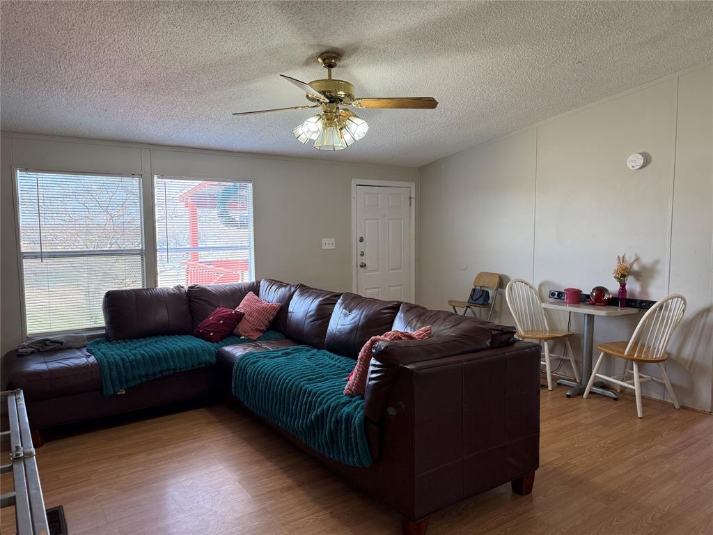 167 Blue Sky Lane Springtown, TX 76082 - Photo 18 of 34 a living room with furniture and a chandelier