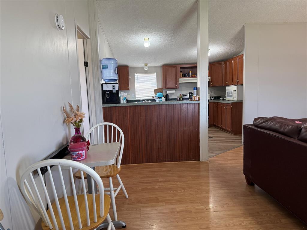 167 Blue Sky Lane Springtown, TX 76082 - Photo 2 of 34 a kitchen with stainless steel appliances granite countertop furniture wooden floor and a kitchen view