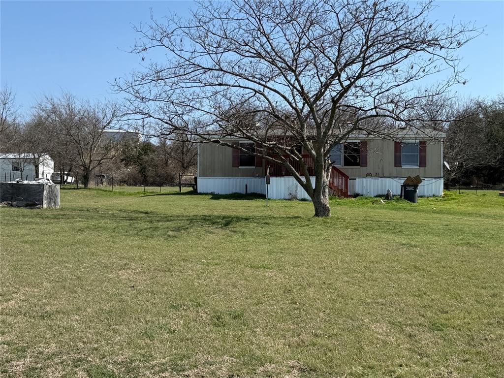 167 Blue Sky Lane Springtown, TX 76082 - Photo 23 of 34 a view of a tree in front of a house