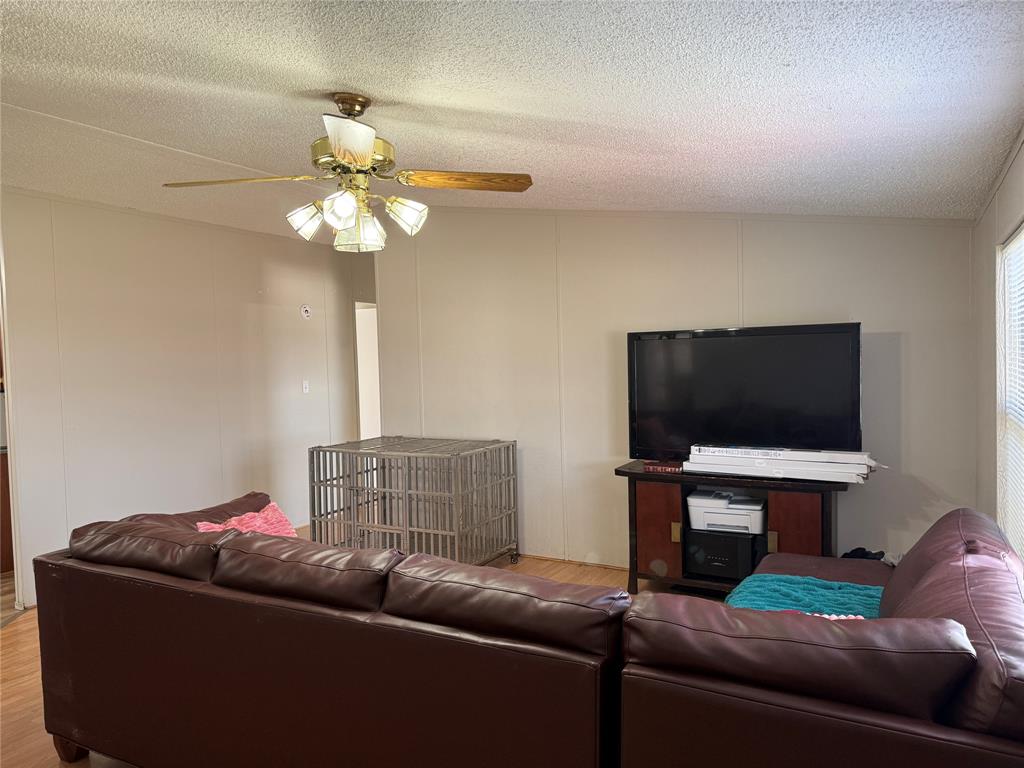 167 Blue Sky Lane Springtown, TX 76082 - Photo 3 of 34 a living room with furniture and a flat screen tv