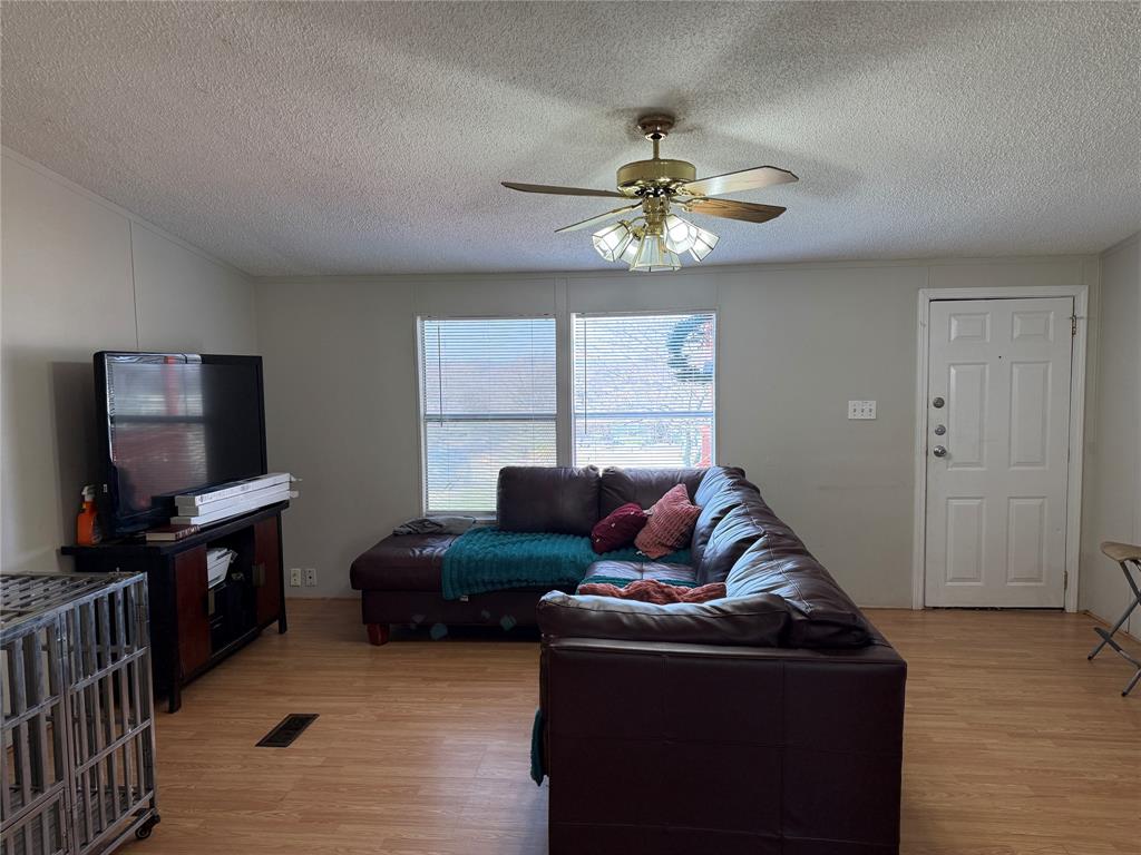 167 Blue Sky Lane Springtown, TX 76082 - Photo 4 of 34 a living room with furniture and a flat screen tv