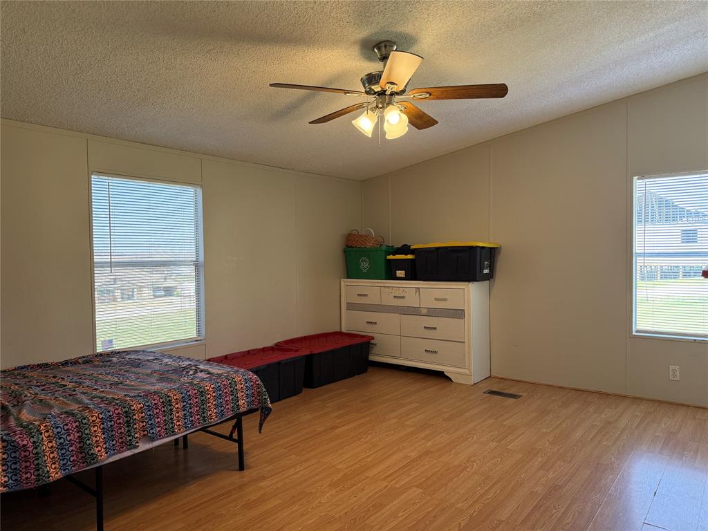 167 Blue Sky Lane Springtown, TX 76082 - Photo 7 of 34 a bedroom with a bed and a window