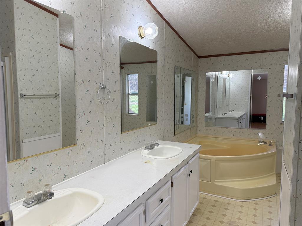 167 Blue Sky Lane Springtown, TX 76082 - Photo 8 of 34 a bathroom with a granite countertop sink toilet and shower