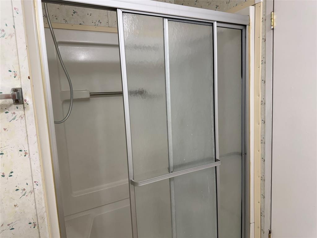 167 Blue Sky Lane Springtown, TX 76082 - Photo 10 of 34 a bathroom with a glass shower door