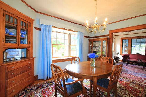 158 Parmenter Road Newton, MA 02465 - Photo 8 of 19 a dining room with wooden floor a chandelier a wooden table and chairs