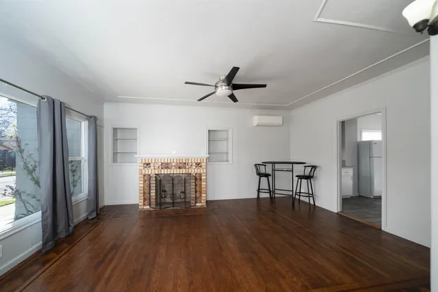a view of a livingroom with furniture wooden floor and a ceiling fan