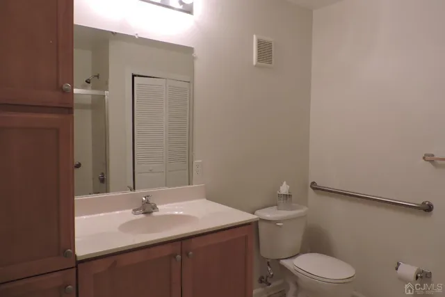a bathroom with a sink a toilet and mirror