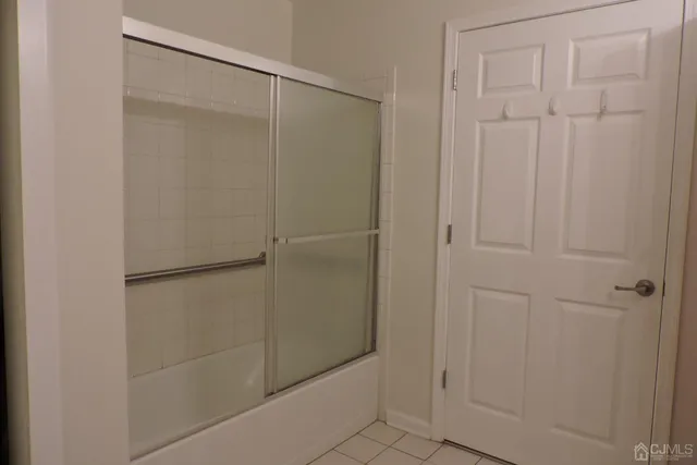 a bathroom with a glass shower door