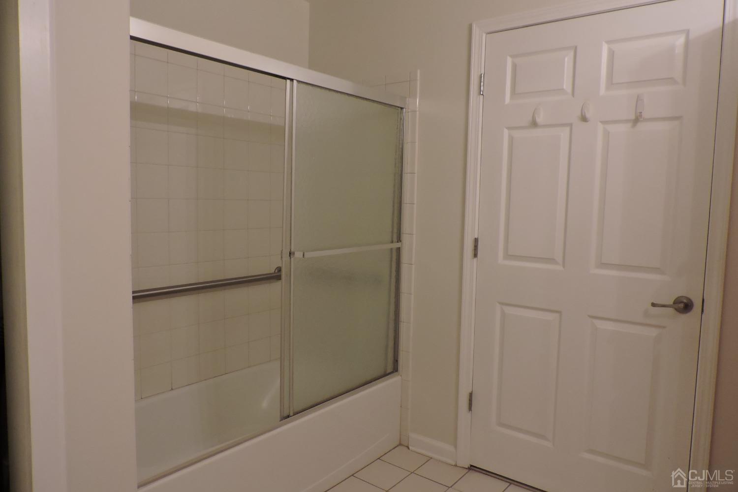 81 Liddle Avenue Edison, NJ 08837 - Photo 14 of 20 a bathroom with a glass shower door
