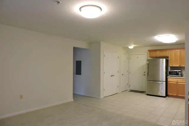 a view of a kitchen with a refrigerator a stove top oven