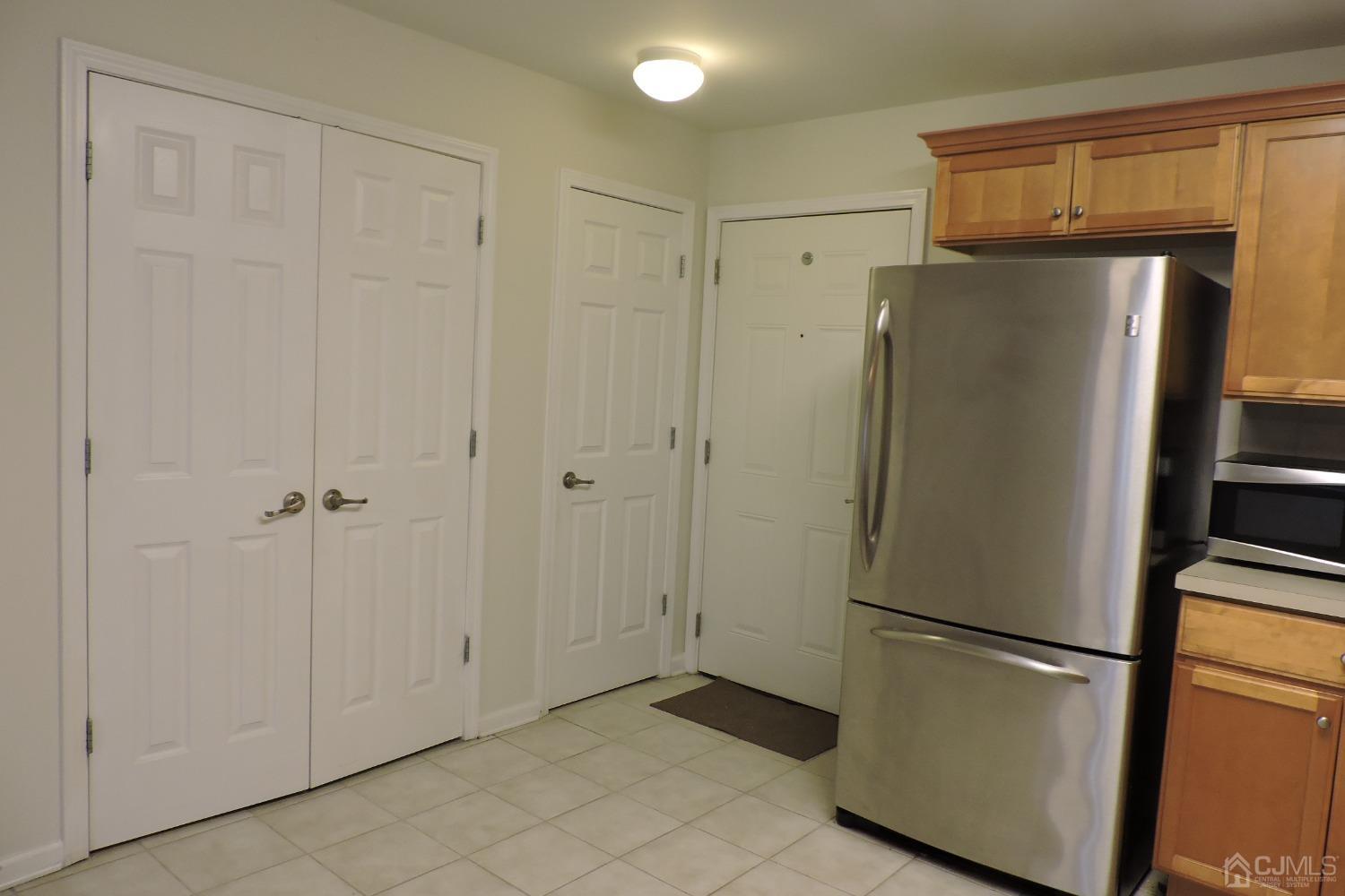 81 Liddle Avenue Edison, NJ 08837 - Photo 10 of 20 a view of a refrigerator in kitchen and white cabinets