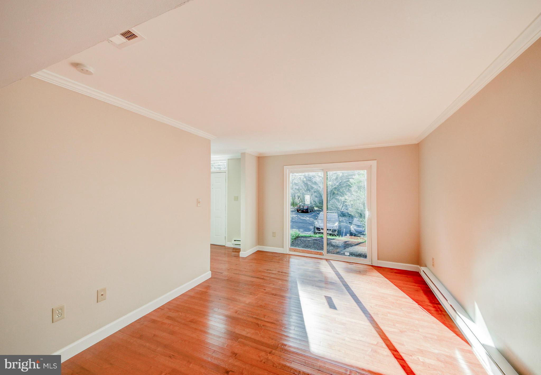 2459 Pyrenees Court Reston, VA 20191 - Photo 12 of 28 a view of an empty room with wooden floor and a window