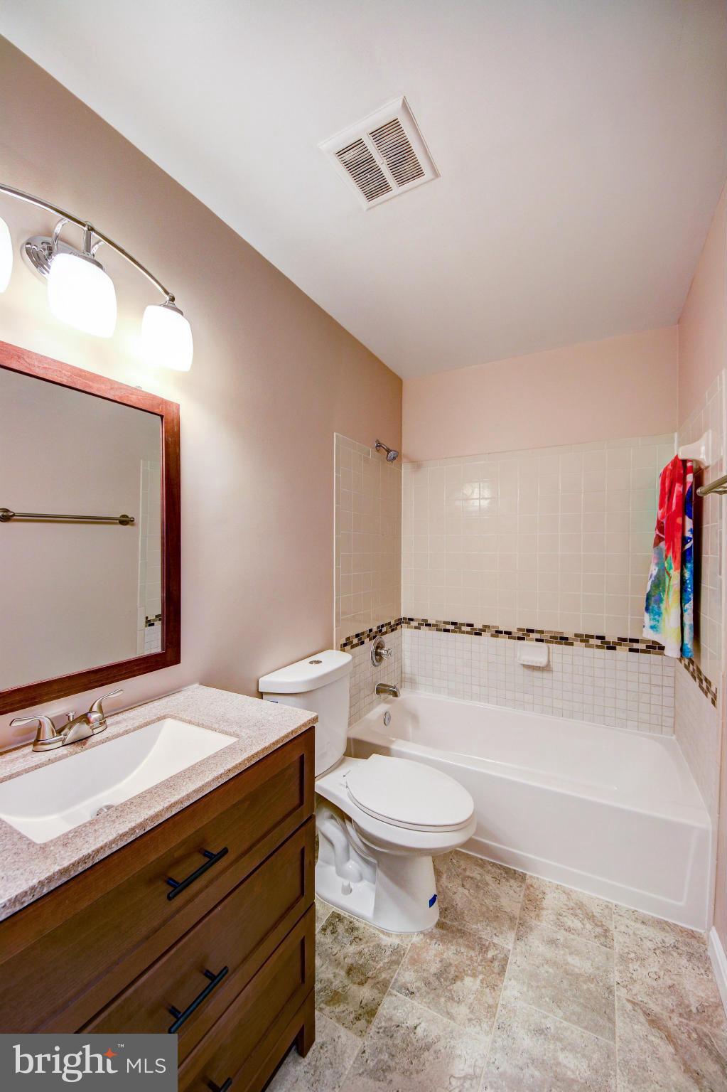 2459 Pyrenees Court Reston, VA 20191 - Photo 17 of 28 a bathroom with a sink a toilet and shower