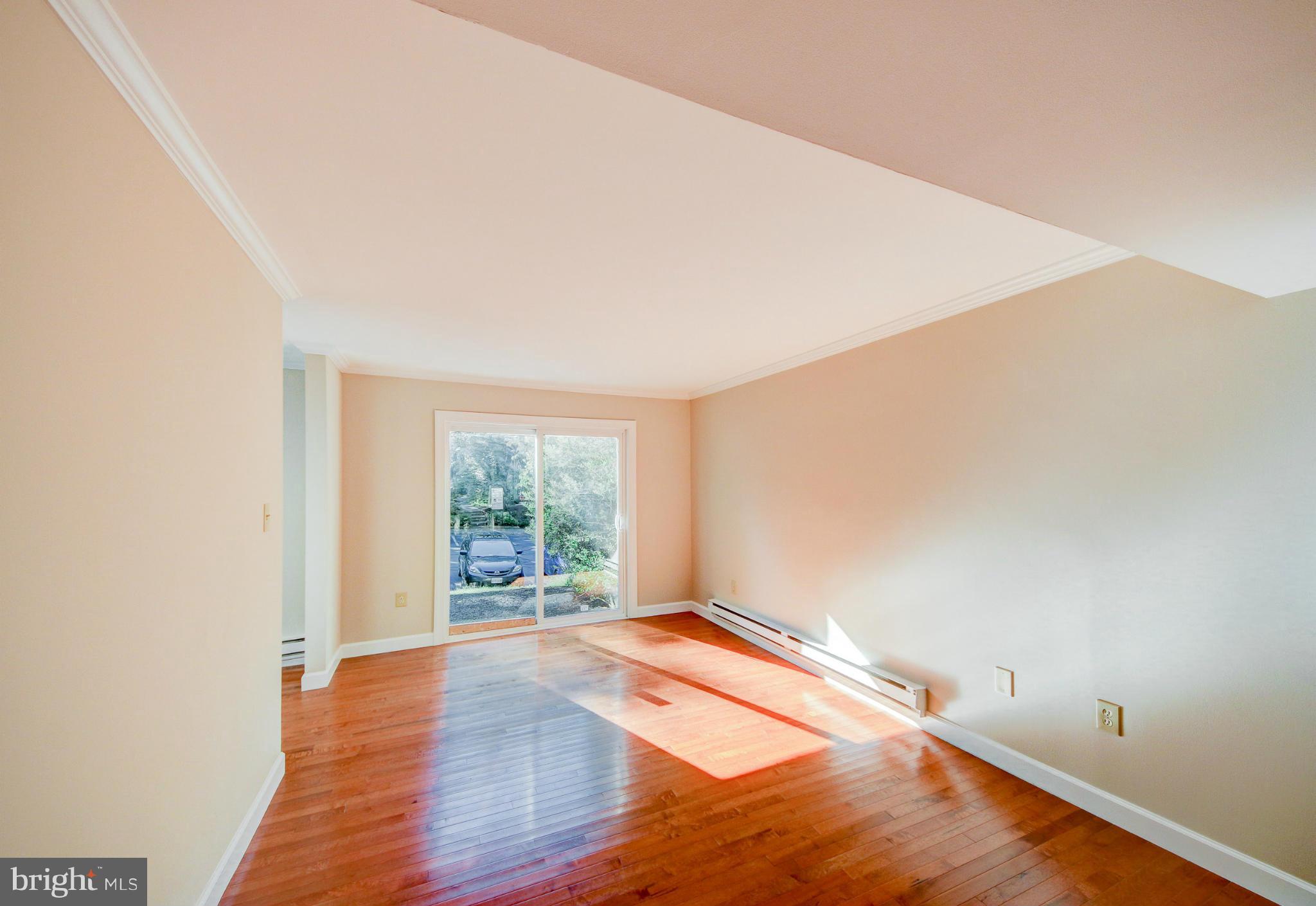 2459 Pyrenees Court Reston, VA 20191 - Photo 9 of 28 an empty room with wooden floor and windows