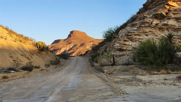 a view of a valley with a mountain in the background