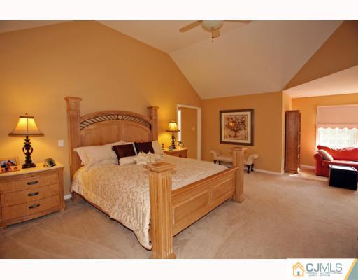 98 Bennett Road Old Bridge, NJ 07747 - Photo 6 of 10 a bedroom with a bed and a lamp