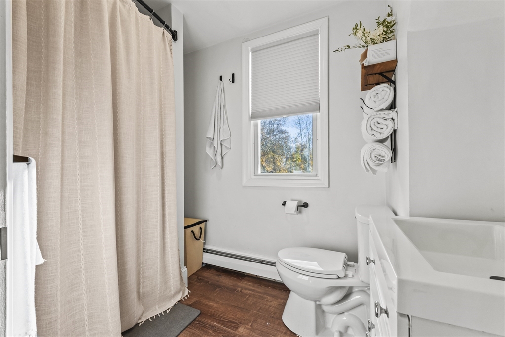 1142 Washington Street Whitman, MA 02382 - Photo 11 of 32 a white toilet sitting next to a bathroom sink