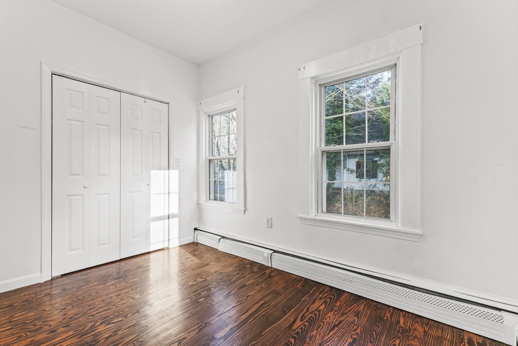1142 Washington Street Whitman, MA 02382 - Photo 15 of 32 an empty room with wooden floor and windows