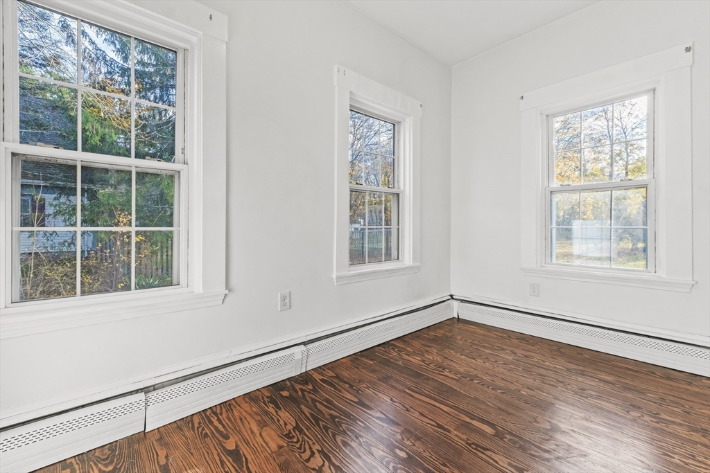1142 Washington Street Whitman, MA 02382 - Photo 16 of 32 a view of an empty room with wooden floor and a window
