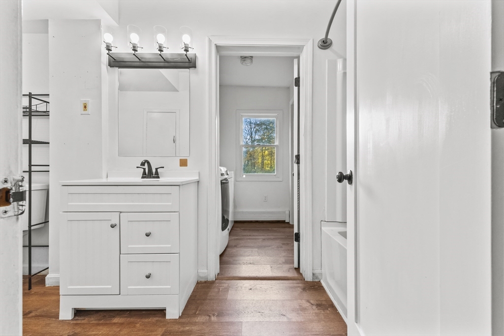 1142 Washington Street Whitman, MA 02382 - Photo 23 of 32 a bathroom with a double vanity sink and mirror