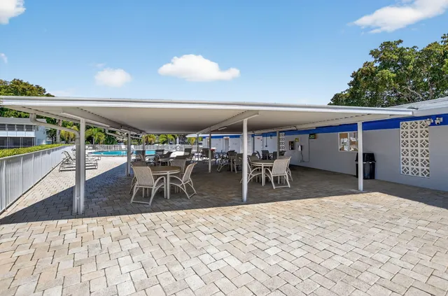 a living room with furniture and a dining table with kitchen view