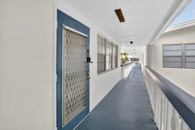 an aerial view of a house with garden space and street view