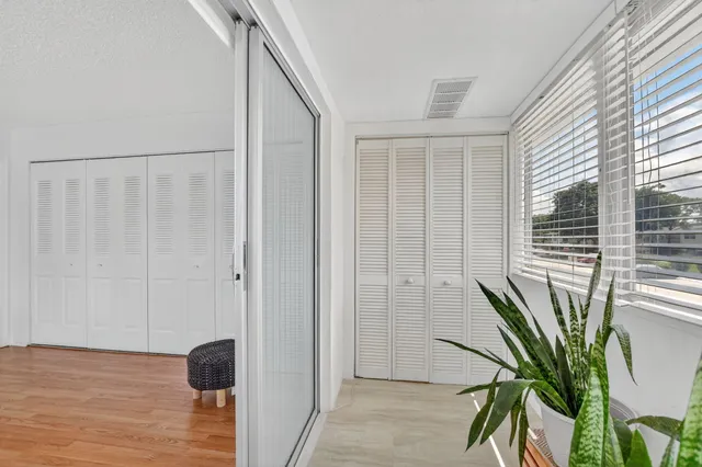 a view of balcony with wooden floor and a potted plant