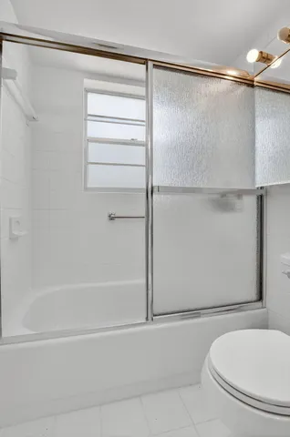 a bathroom with a shower and a toilet