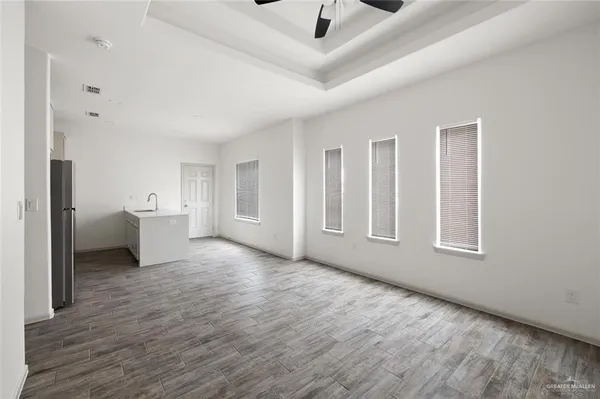 a big room with wooden floor and windows