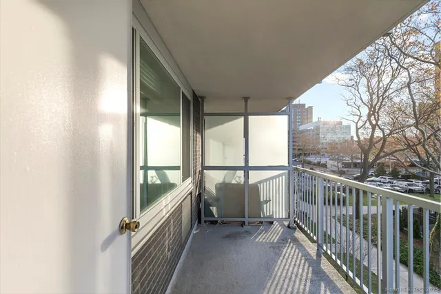 a view of balcony with floor to ceiling window and wooden fence